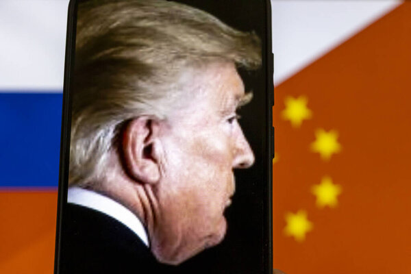 Warsaw Poland - September 17 2025: Profile of Donald Trump displayed on a smartphone screen against blurred flags of Russia and China highlighting global political tensions.