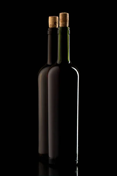 stock image Wine bottles with cork and on black isolated background