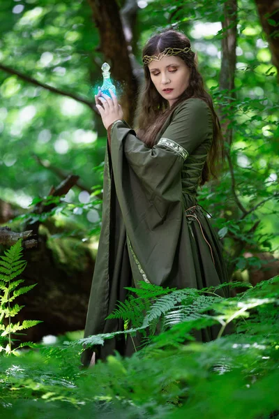 Elf with a bottle of magic potion in the forest — Stock Photo, Image