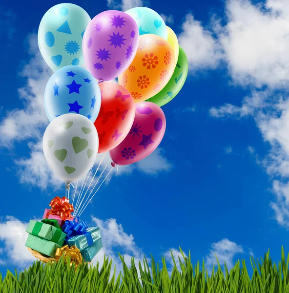 Boxes with gifts in balloons against the sky — Stock Photo, Image