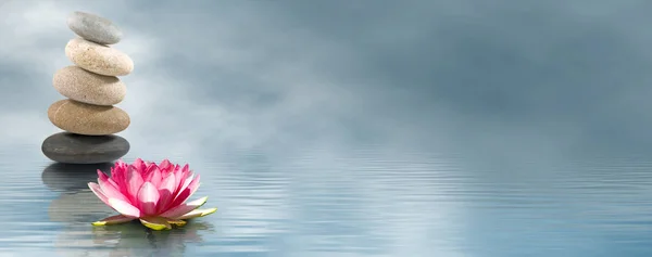 Lotus flower and stones on water — Stock Photo, Image