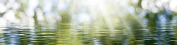 Obraz Powierzchni Wody Oświetlonej Promieniami Światła Szeroki Format — Zdjęcie stockowe
