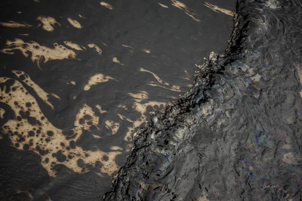 Texture of Crude oil spill on sand beach from oil spill accident