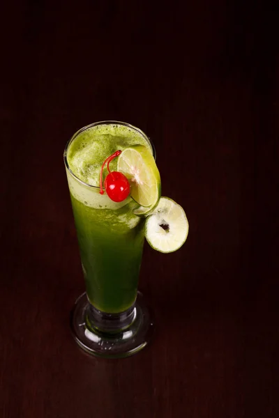 Green wheat grass juice, barley grass blades and ground powder on white background. Natural herbal medicine, living healthy.