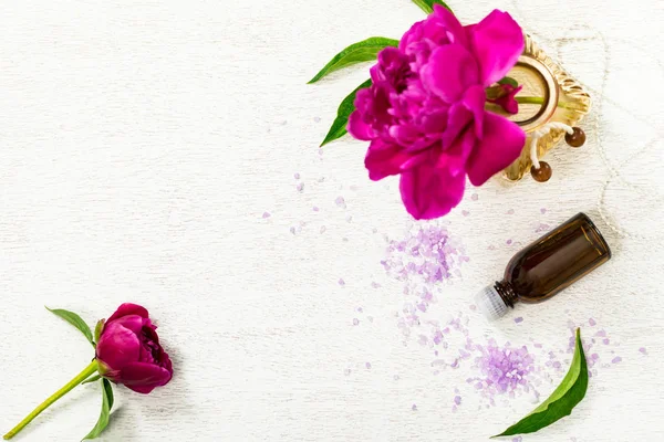 Top view of Spa Theme Objects Essential Oil and Spa Theme Objects with Fresh Peony Flowers. Selective focus.