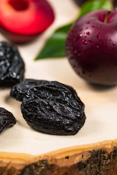 Dried Plums Pitted Prunes and Fresh Plums Background. Selective focus.