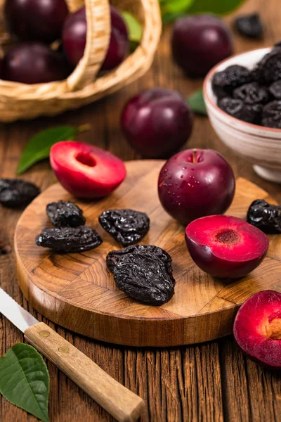 Dried Plums Pitted Prunes and Fresh Plums Background. Selective focus.