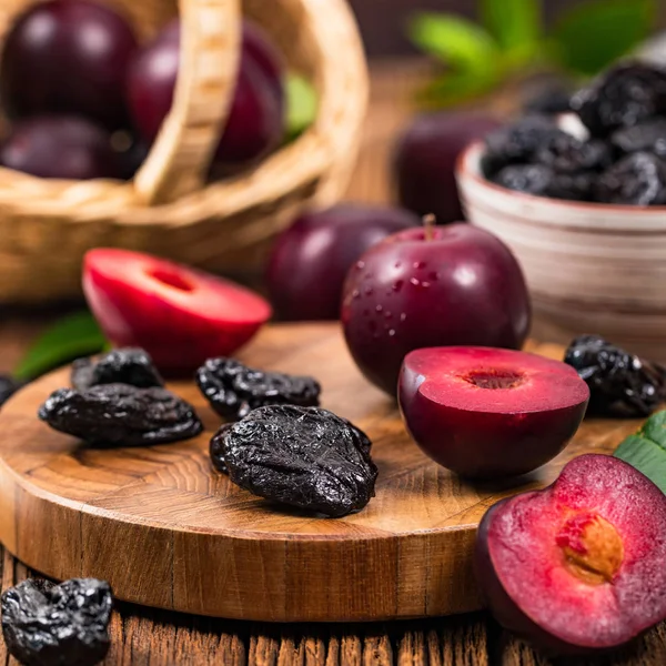 Dried Plums Pitted Prunes and Fresh Plums Background. Selective focus.