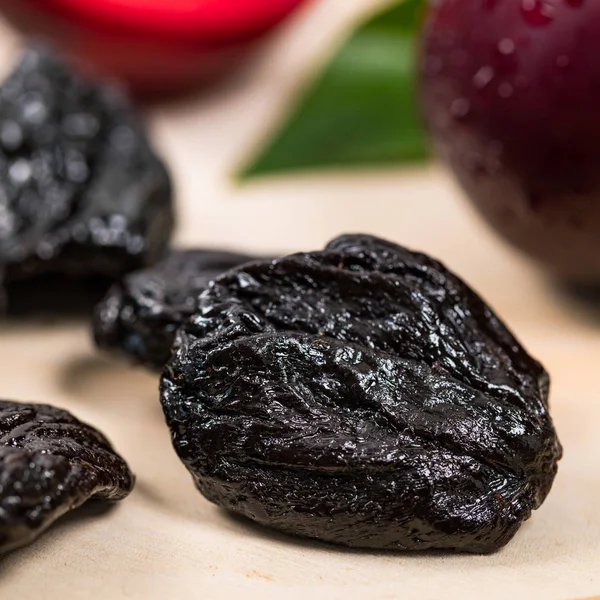 Dried Plums Pitted Prunes and Fresh Plums Background. Selective focus.