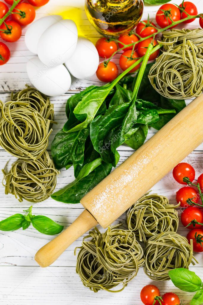 Spinach and Basil Pasta Nests on Wooden Background. Selective focus.