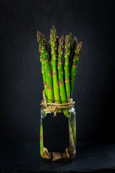 Fresh Asparagus Glass Jar Black Background Blank Chalkboard Label Selective — Stock Photo, Image