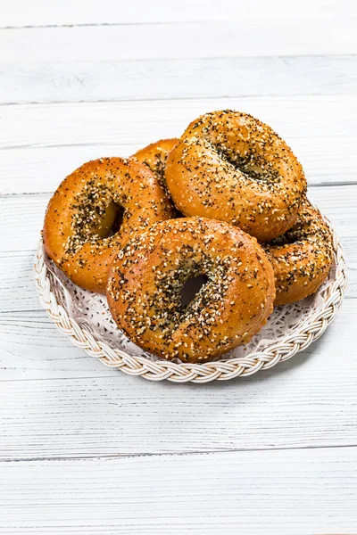 Freshly Baked Bagels Topped with Sesame Seeds, Poppyseeds, Garlic and Onion. Selective focus.