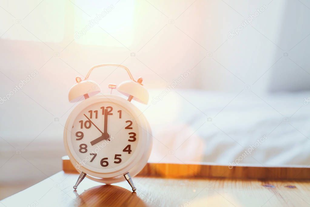 morning time background, alarm clock near the bed at home