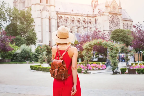フランスのノートルダム大聖堂近くのバックパックと観光に移動する美しい女性のファッション — ストック写真