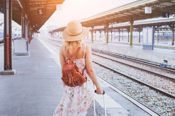 夏の旅行 鉄道駅のプラットホームの彼女の列車を待っているスーツケースを持つ女性 — ストック写真