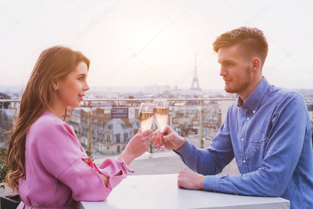 romantic dinner for couple in luxurious restaurant in Paris with panoramic city view and Eiffel tower