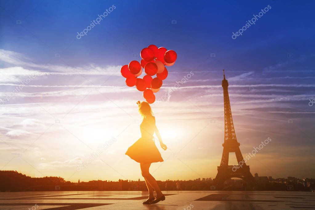 silhouette of woman with red balloons near Eiffel tower in Paris