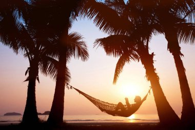kadın güzel günbatımı Plajı, tatil kavramı üzerinde hamakta rahatlatıcı