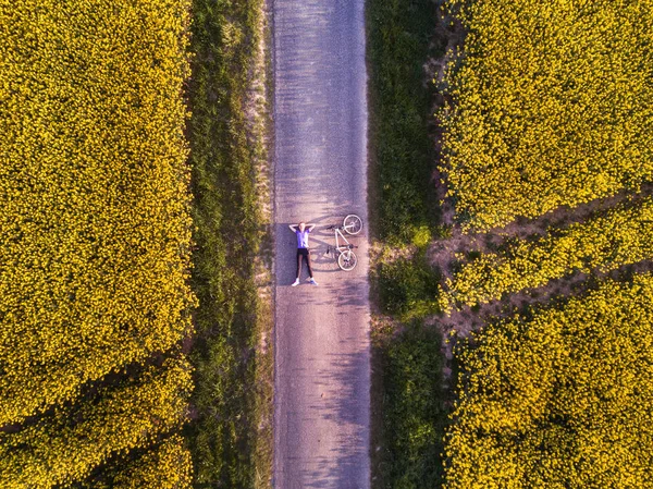 在田野里的道路上 有自行车的人的最高视野 空中射击 — 图库照片