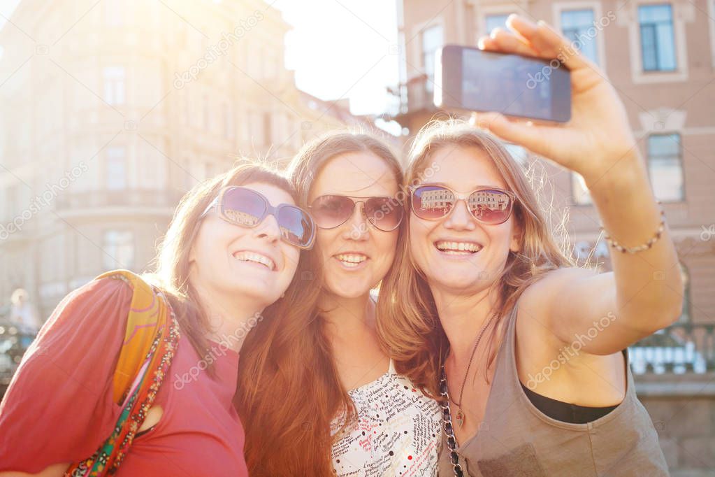 tourists in european city, travel in Europe, group of happy friends taking photo selfy