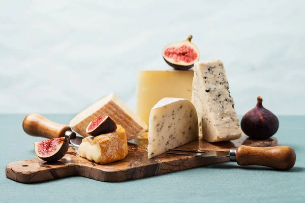 Cheese board: variety of cheeses on marble serving board