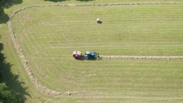 Blue Tractor Hay Bales Trees Aerial View — Stock Video