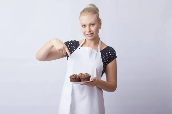 Счастливая Блондинка Белом Фартуке Показывает Шоколадные Кексы Белой Тарелке Повар — стоковое фото