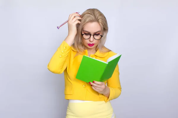 Porträtt av blond kvinna med böcker och penna — Stockfoto