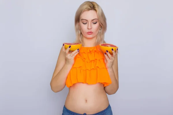 Blonde Frau mit Grapefruitscheiben — Stockfoto