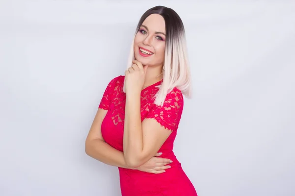 Young blonde woman over white background in bright pink dress — Stock Photo, Image