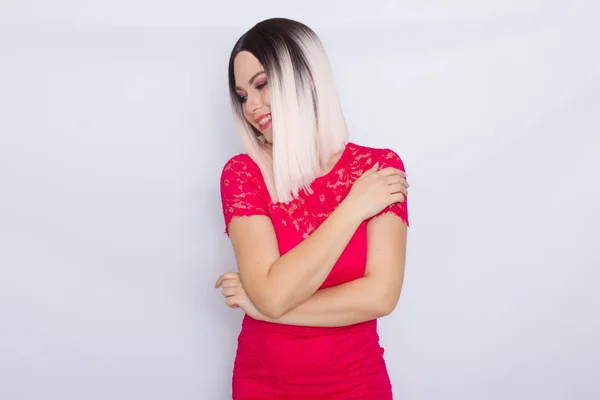 Young blonde woman over white background in bright pink dress — Stock Photo, Image