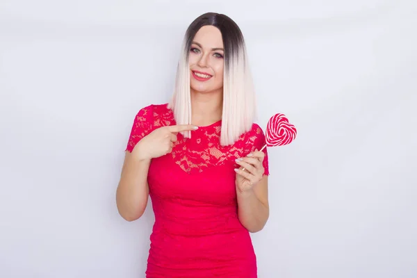 Blonde woman with heart candy in her hands