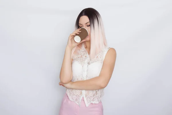 Blonde woman in white shirt with cup of coffee — Stock Photo, Image