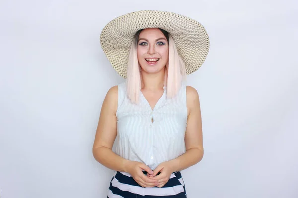 Young blonde woman with big white summer hat