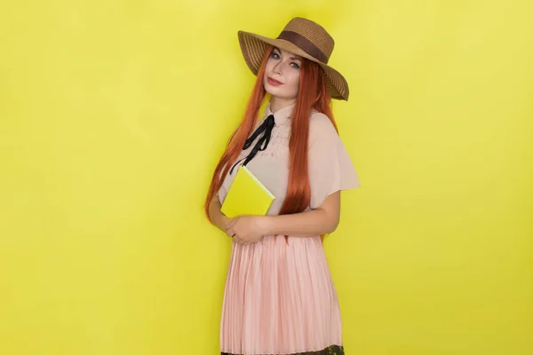 Red Haired Woman Straw Hat Yellow Background Holding Book Her — Stock Photo, Image