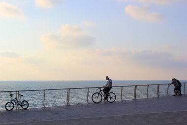 Deniz-gün batımı arka cephesinde insanlara 