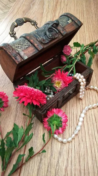 wooden chest with white pearls and flowers
