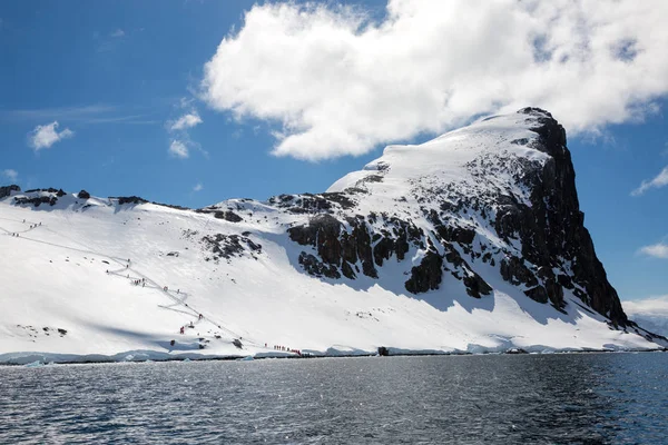 icecaps in the Antarctica with iceberg in the ocean swimming around and melting in the sea