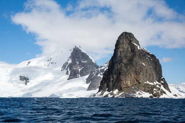 icecaps in the Antarctica with iceberg in the ocean swimming around and melting in the sea