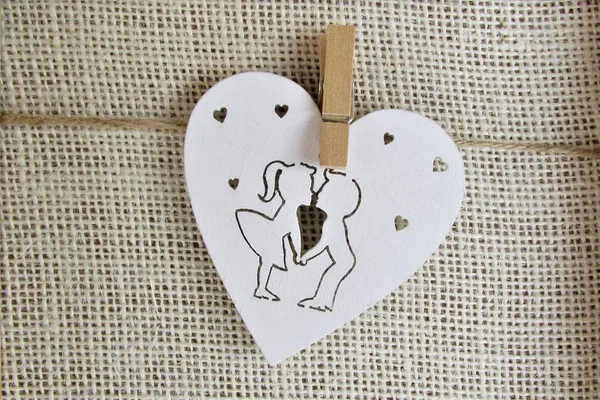 Loving couple on white wooden heart