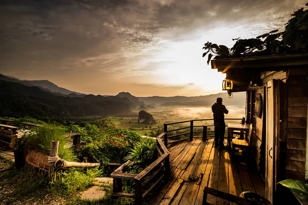 Sea of fog effect on winter morning with sunrise , Coffee shop on the mountain with the beautiful view point