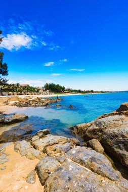 Vietnam'da bir bulut ile mavi gökyüzüne karşı Güney Çin Denizi'nin güzel taşlı sahil