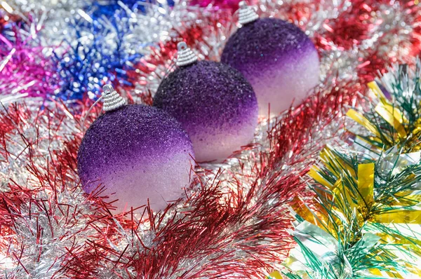 Three New Year Balls Lie Tinsel — Stock Photo, Image