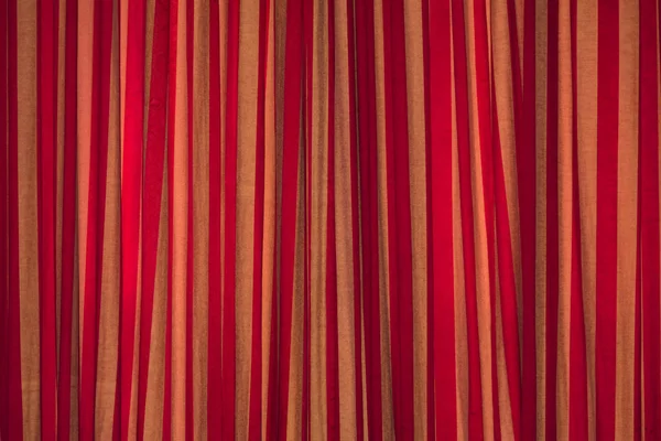 dense textile red curtain background with folds