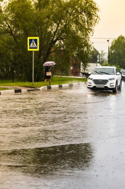 - Rusya. Moskova. 29 Mayıs 2020. Bir araba su birikintisinin içinden su sıçratarak geçiyor. Şehirde bahar seli.