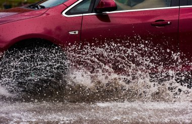 Hareket eden araba yağmuru Tekerleklerden fışkıran su birikintisi