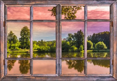 Sabahın erken saatlerinde pencereden gölet ve ağaçların üzerinden...