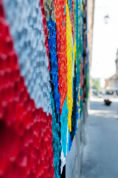 Close-up on plastic bottle caps. Art made of multi colored bottle caps.