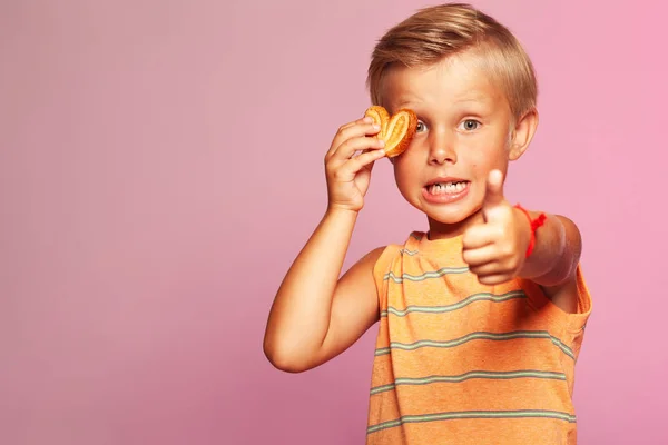 Mama's boy, sweet tooth concept. Funny portrait of shocked boy with cookie — Stock Photo, Image
