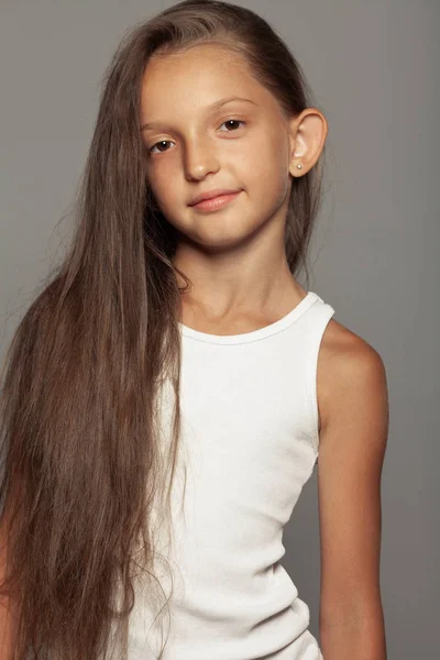 Little beauty concept. Portrait of young girl with long healthy hair — Stock Photo, Image